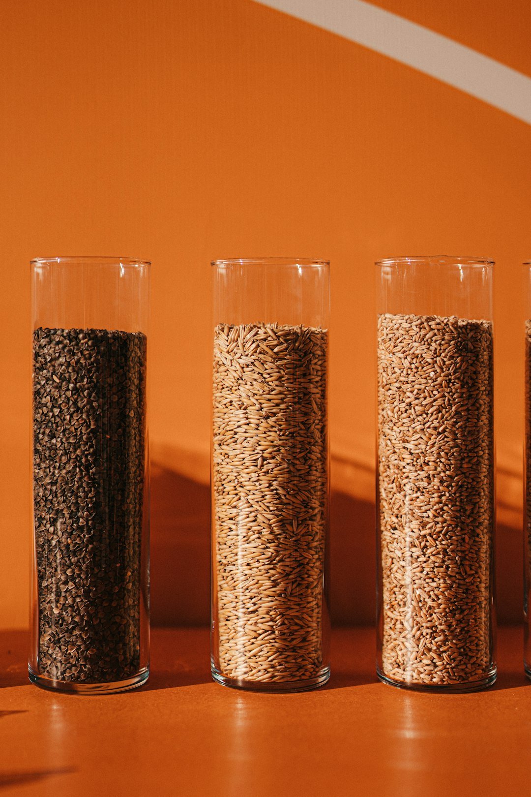 a-row-of-three-glasses-filled-with-grains-9excdrrsk3i